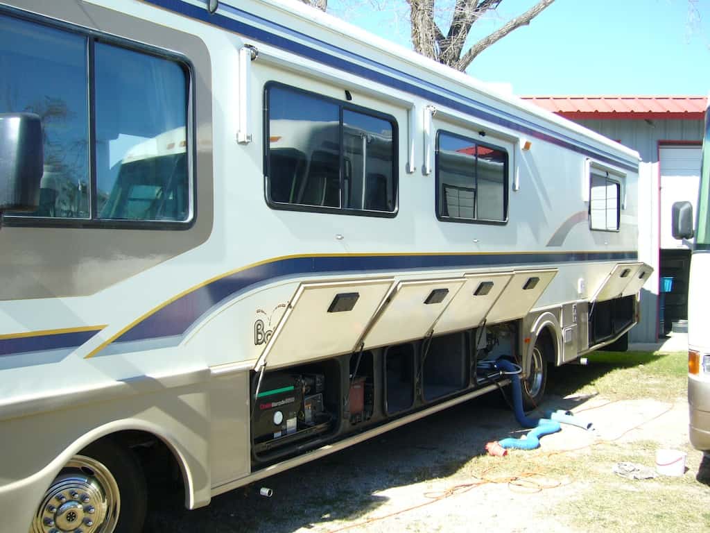 Storage compartments in a 5th wheel trailer and a class A motorhome